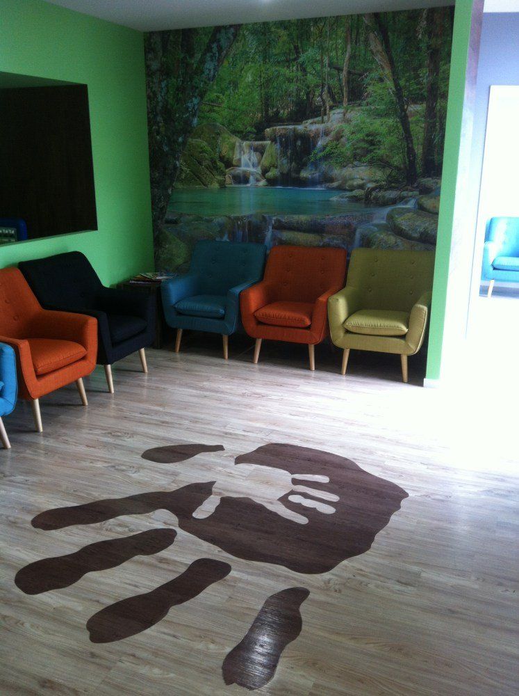 A room with chairs and a hand print on the floor — Red Emperor Constructions in Cannonvale, QLD