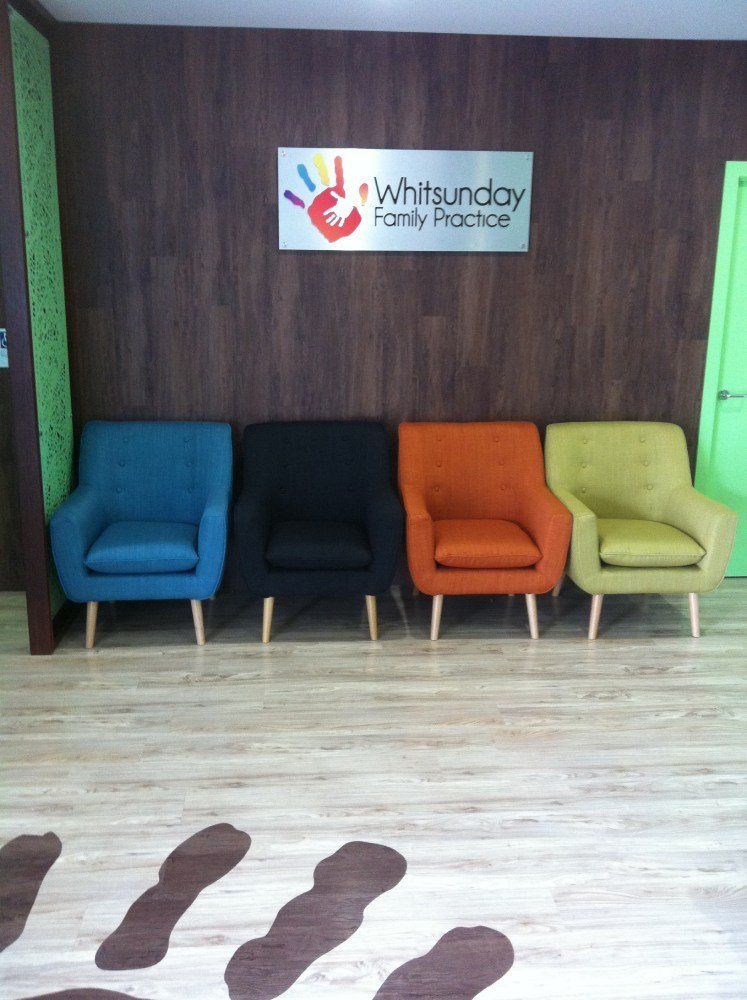 A row of chairs with a sign above them that says whitsunday family practice — Red Emperor Constructions in Cannonvale, QLD