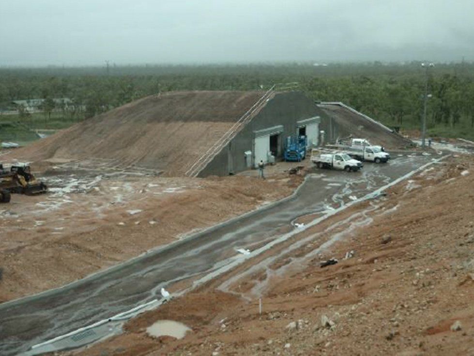 A large building is being built on top of a dirt hill — Red Emperor Constructions in Cannonvale, QLD