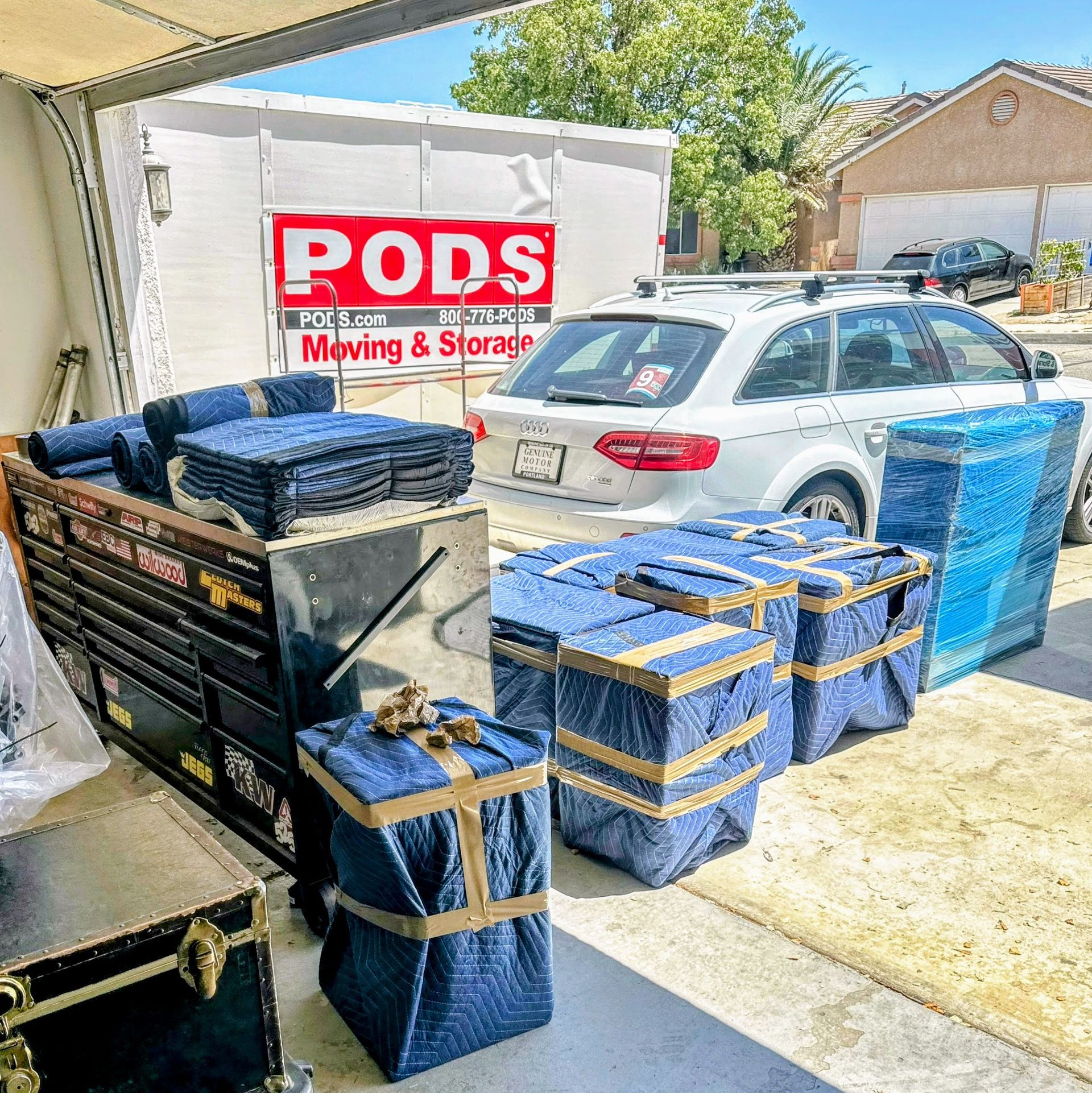 The back of a van filled with appliances wrapped in plastic