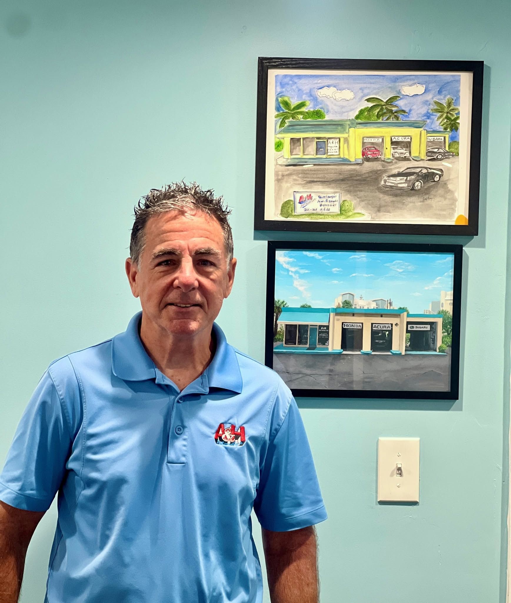 Smiling man in a blue polo shirt standing against a beige wall. Smiling man in a blue polo shirt standing against a beige wall.