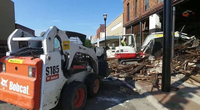 A bobcat skid steer is parked on the side of the road