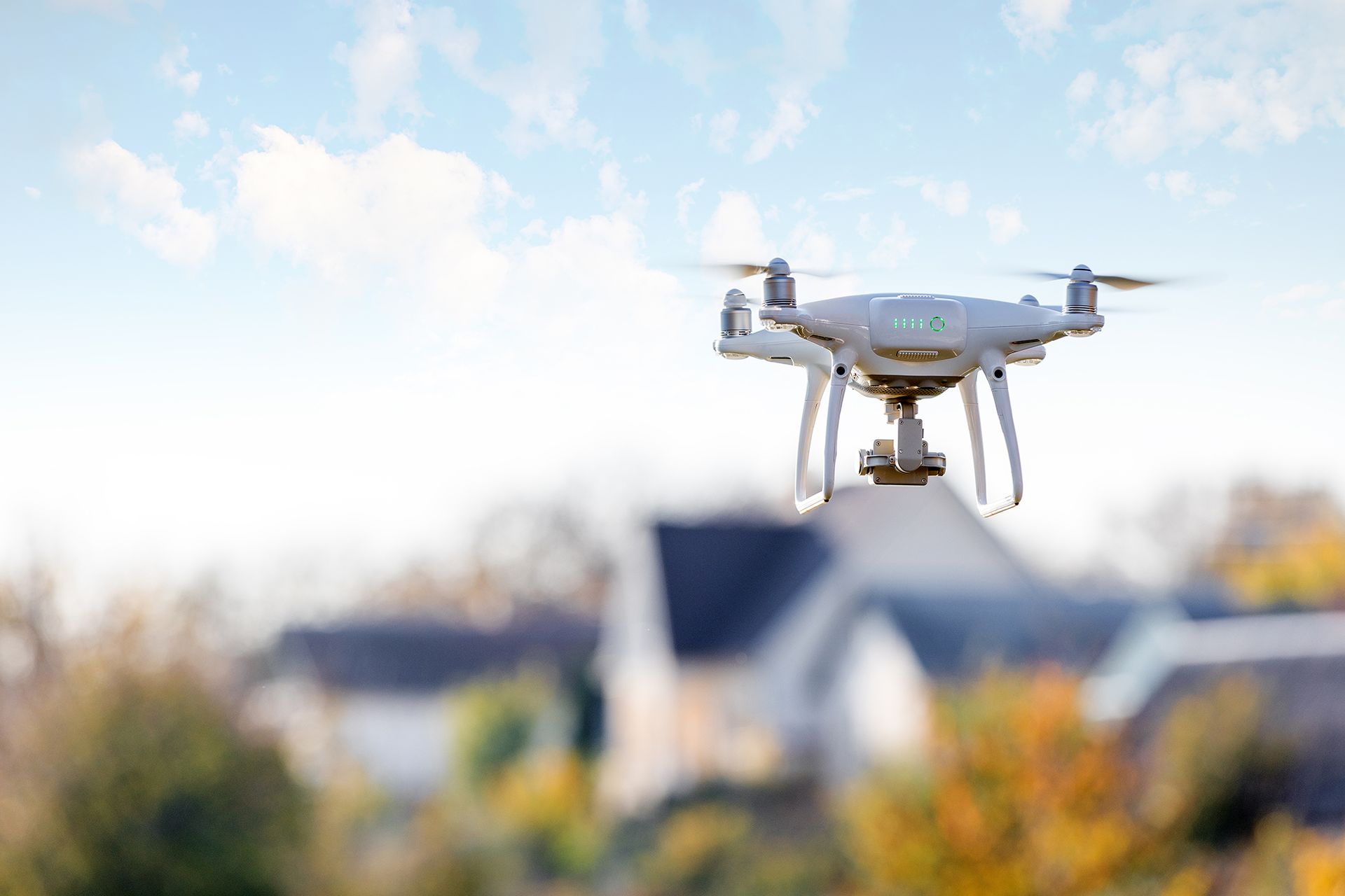 A drone is flying over a house in a residential area.