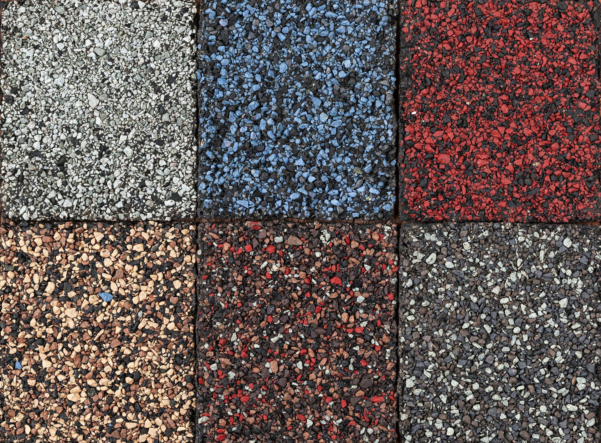 A close up of a variety of different colored rubber tiles.