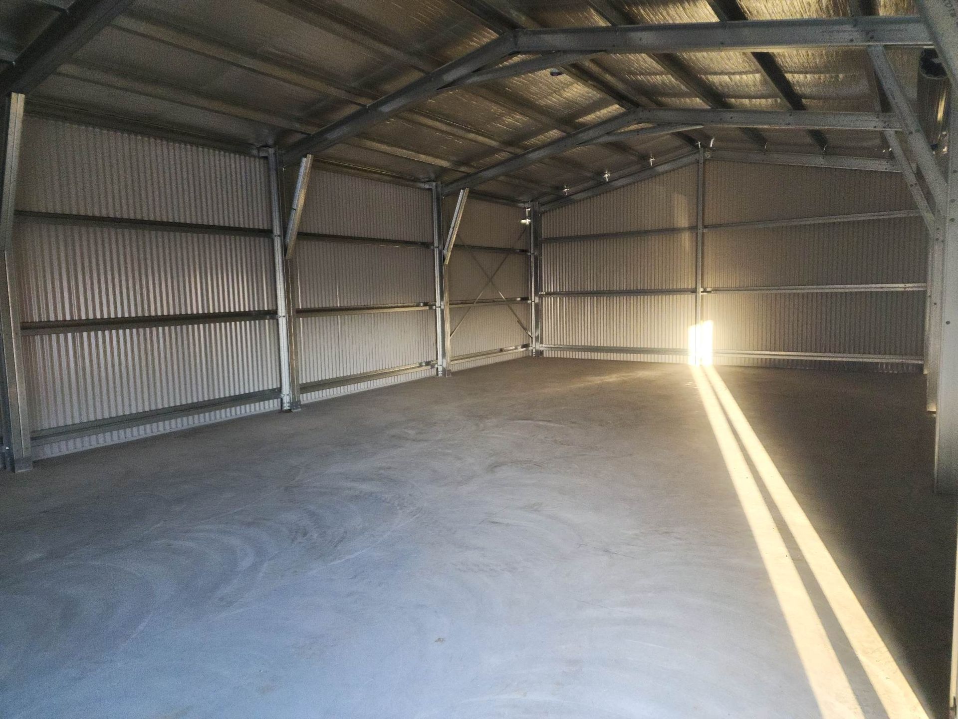 Interior of An Empty Warehouse with Metal Walls and Ceiling — BF Sheds & Garages In Rockhampton, QLD