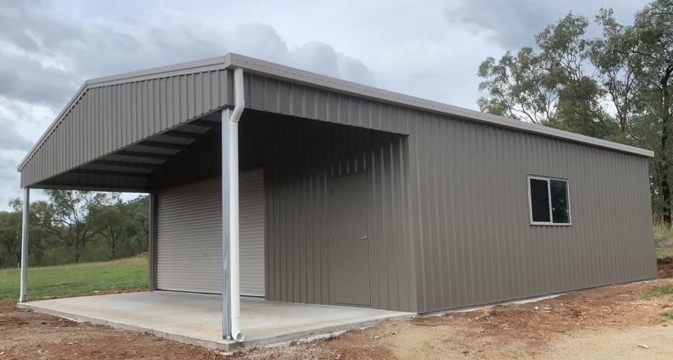 A Gray, Metal-Sided Shed with An Open Carport Area on One Side and A Single Window — BF Sheds & Garages In Rockhampton, QLD