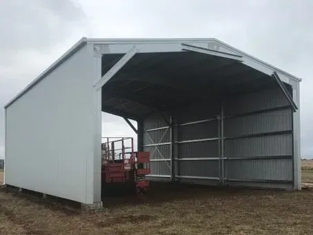 A White Metal Shed with An Open Front and Corrugated Steel Sides — BF Sheds & Garages In Rockhampton, QLD