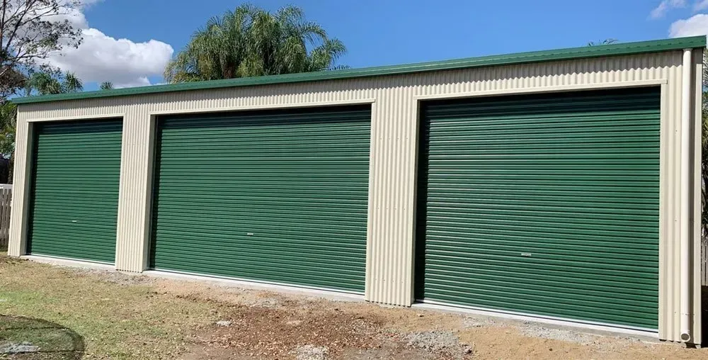 A Three-Bay, Cream-Colored Metal Shed — BF Sheds & Garages In Rockhampton, QLD