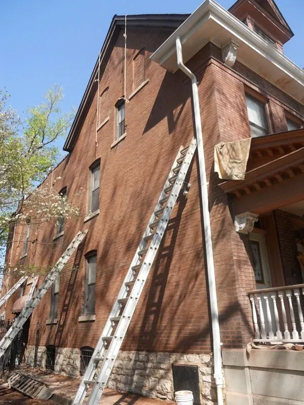 Brick House With Ladder — St. Louis, MO — Mirelli Tuckpointing LLC