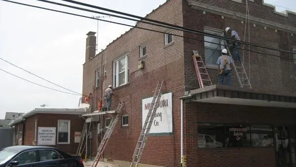 Men Working On Bricks Of A Building — St. Louis, MO — Mirelli Tuckpointing LLC