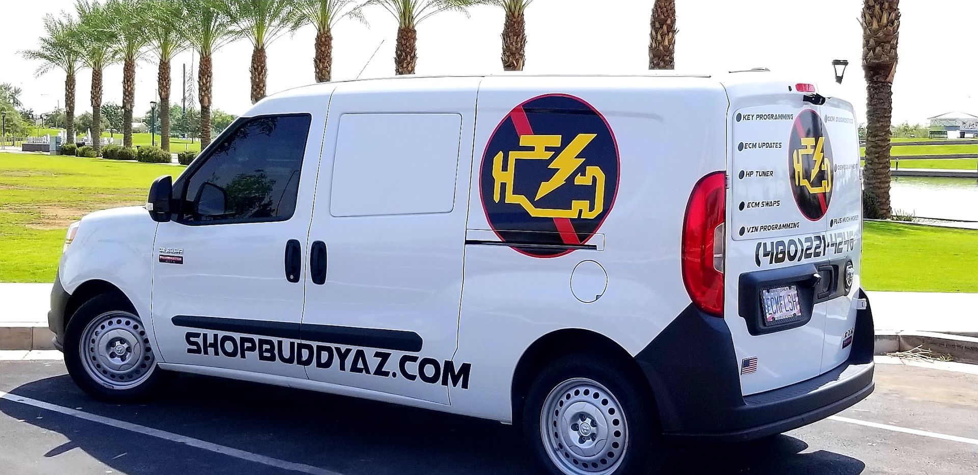 White ShopBuddy van with logo parked beside palm trees on a sunny street