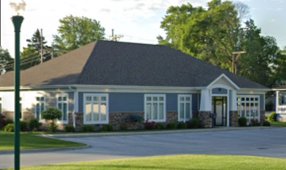 A blue and white house with a gray roof. A blue and white house with a gray roof