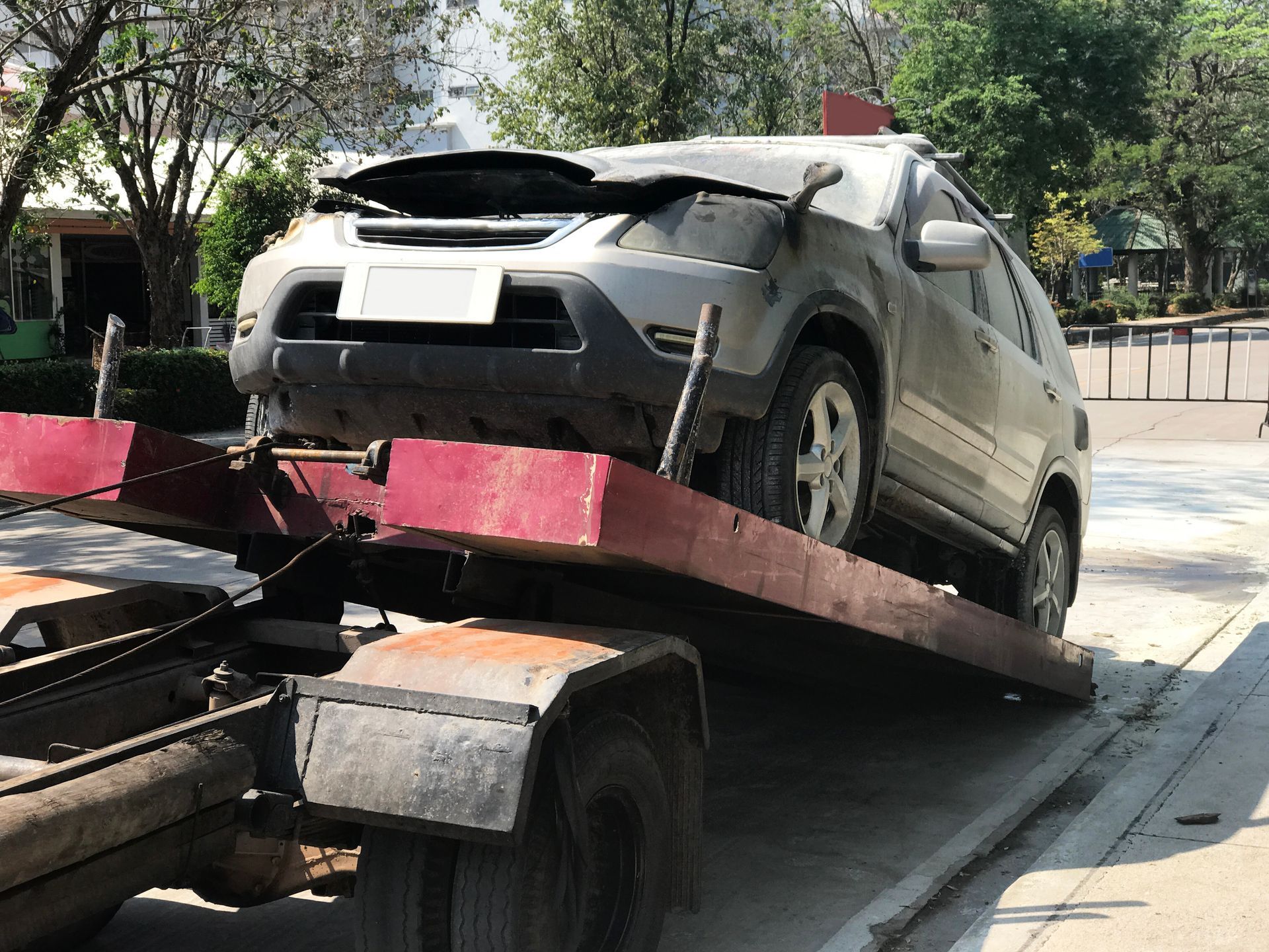 A car is being towed by a tow truck.