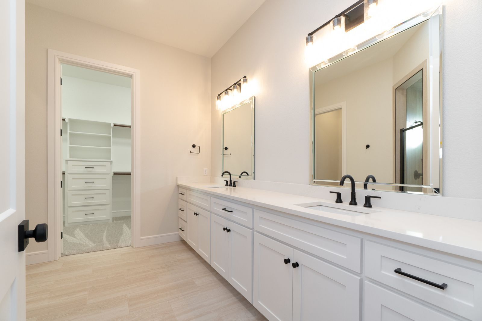 A bathroom with two sinks and two mirrors