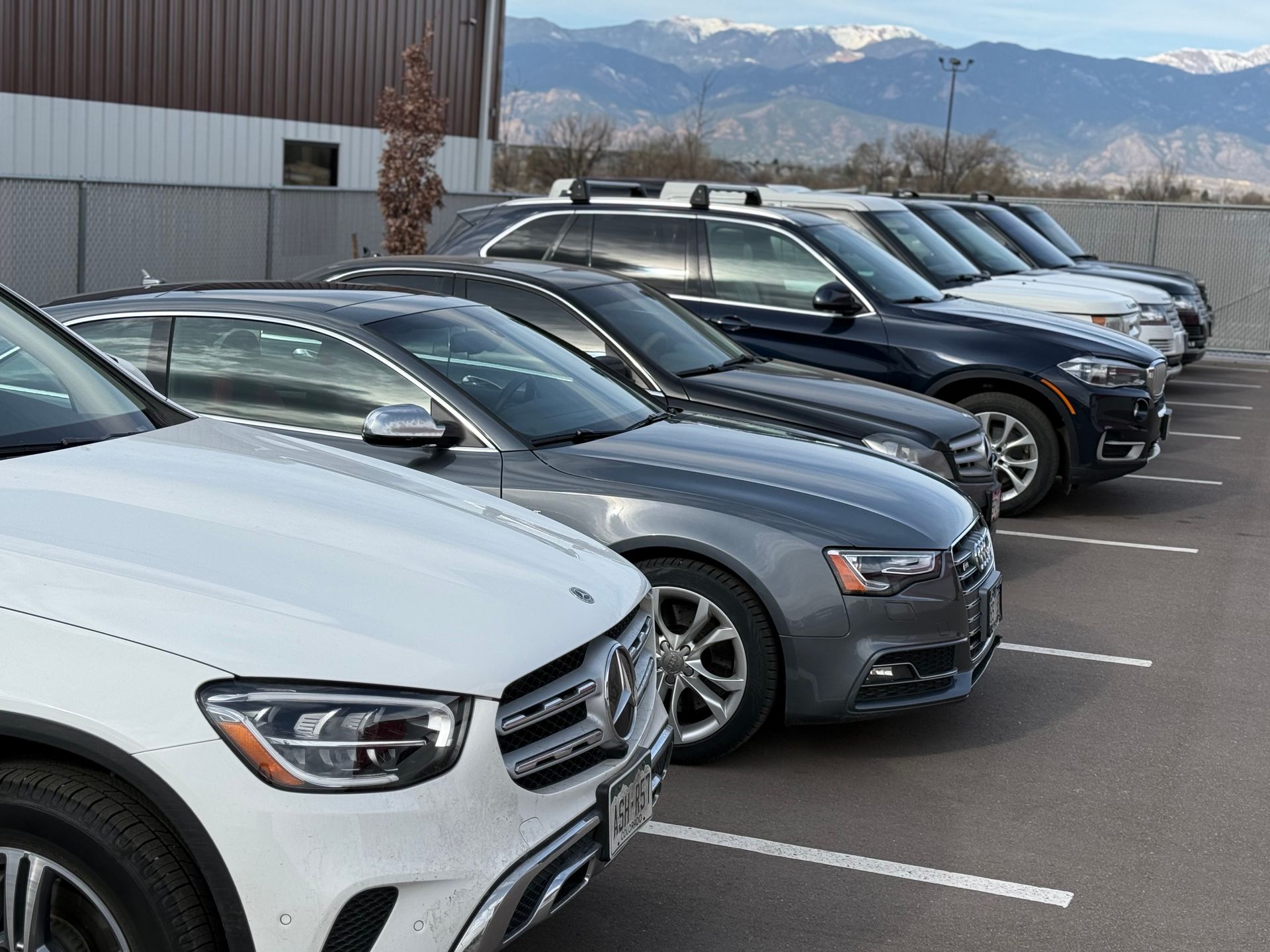 Row of parked luxury cars | Peak European