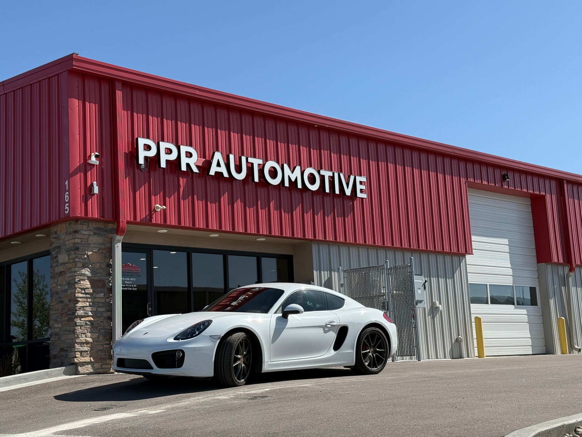 White sports car parked in front of Peak European | Peak European