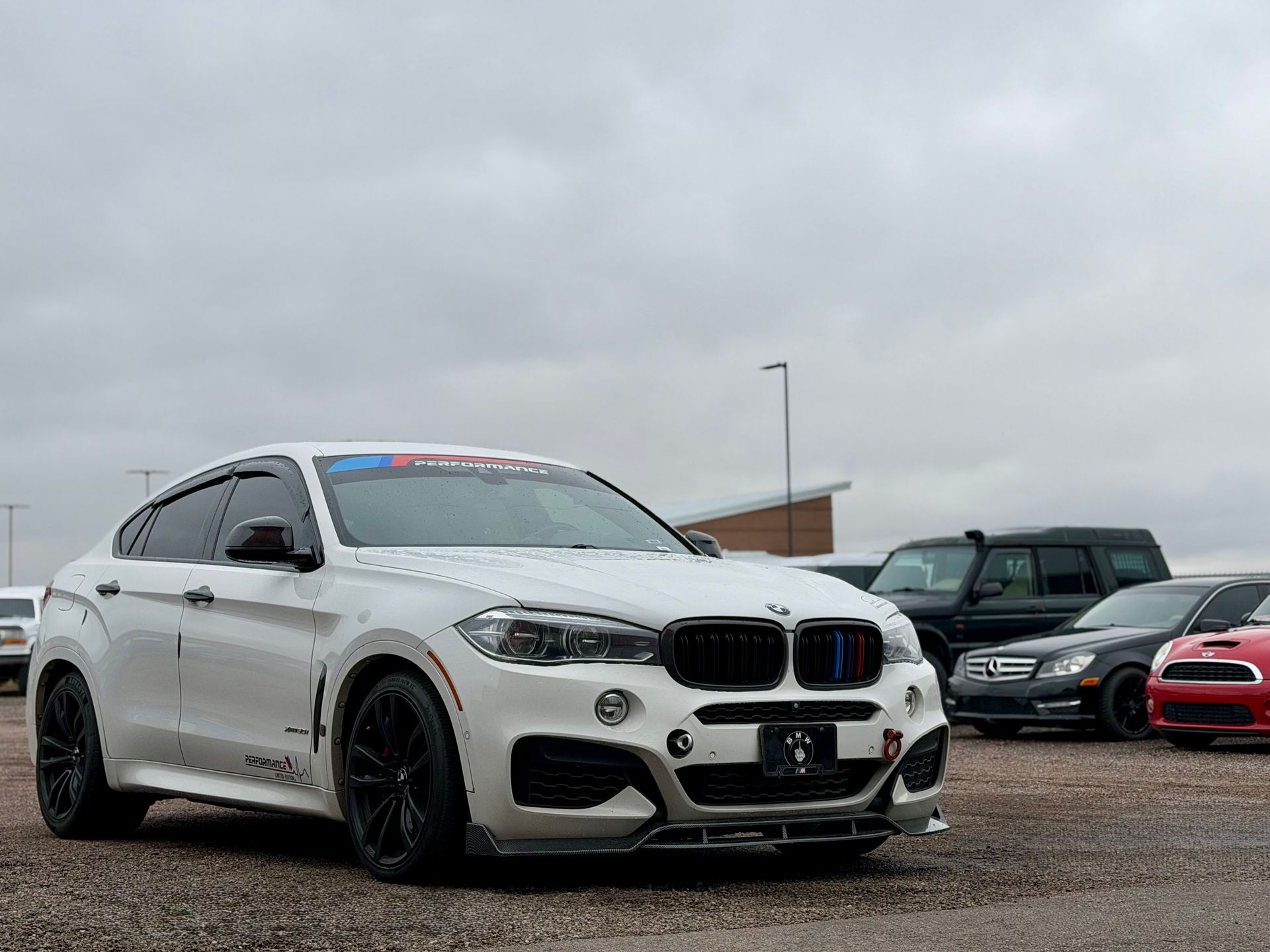 White BMW SUV in a parking lot on a cloudy day