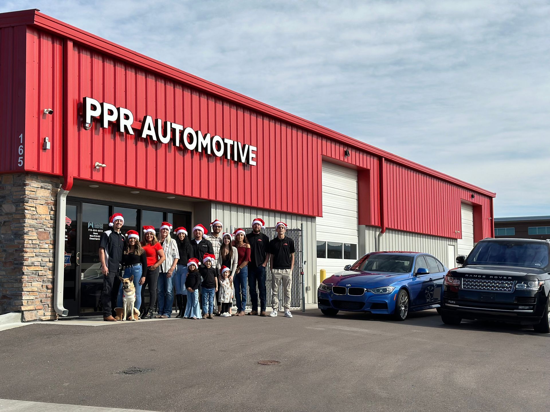 Peak European team wearing Santa hats poses in front of the shop | Peak European