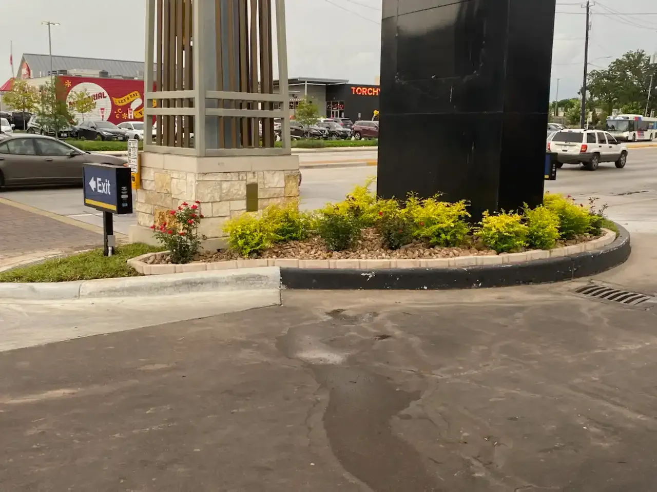 A parking lot with a statue in the middle of it