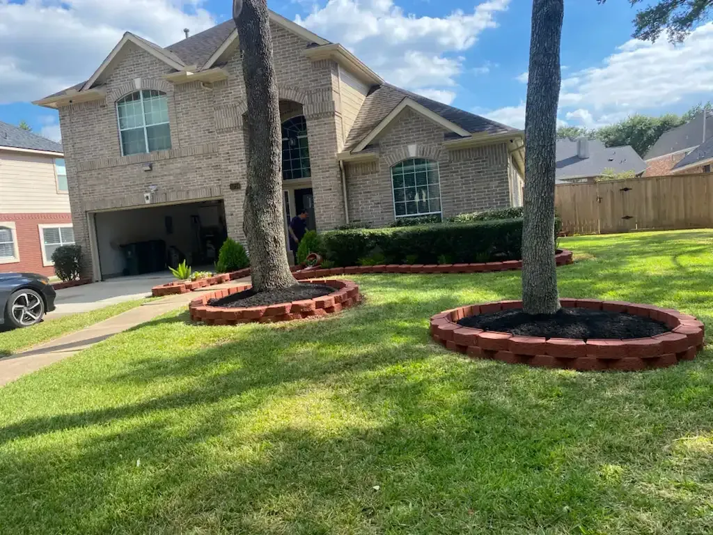 A large brick house with a car parked in front of it.