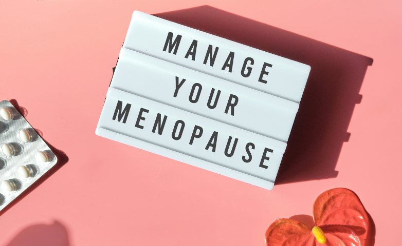 White lightbox on pink background reading “MANAGE YOUR MENOPAUSE,” with pills and flowers