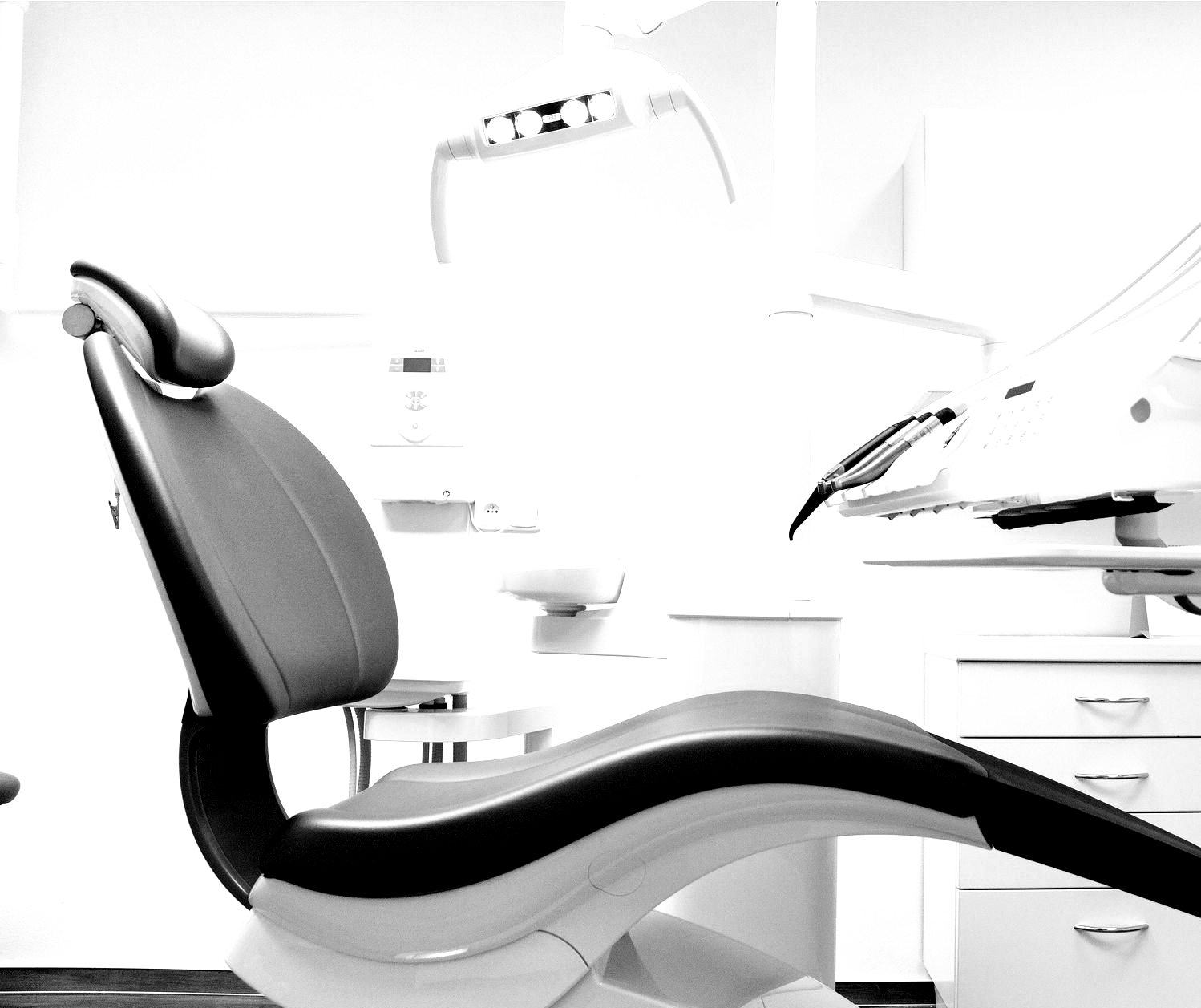 Modern dental chair in a bright clinic with overhead lamp and cabinets