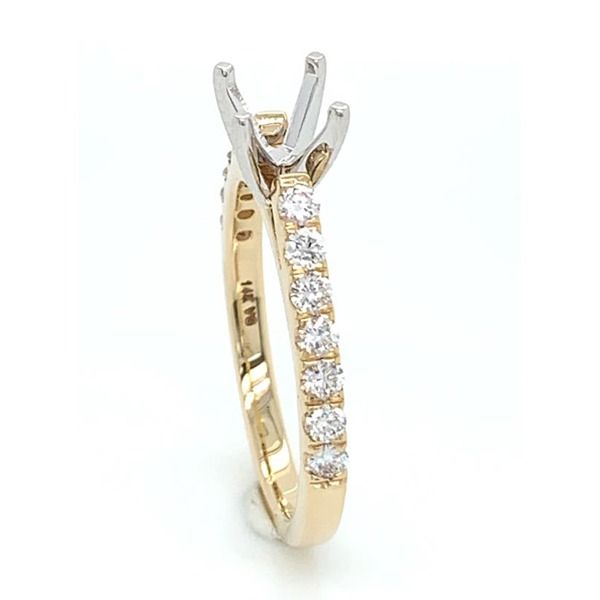 A yellow gold ring with diamonds on it