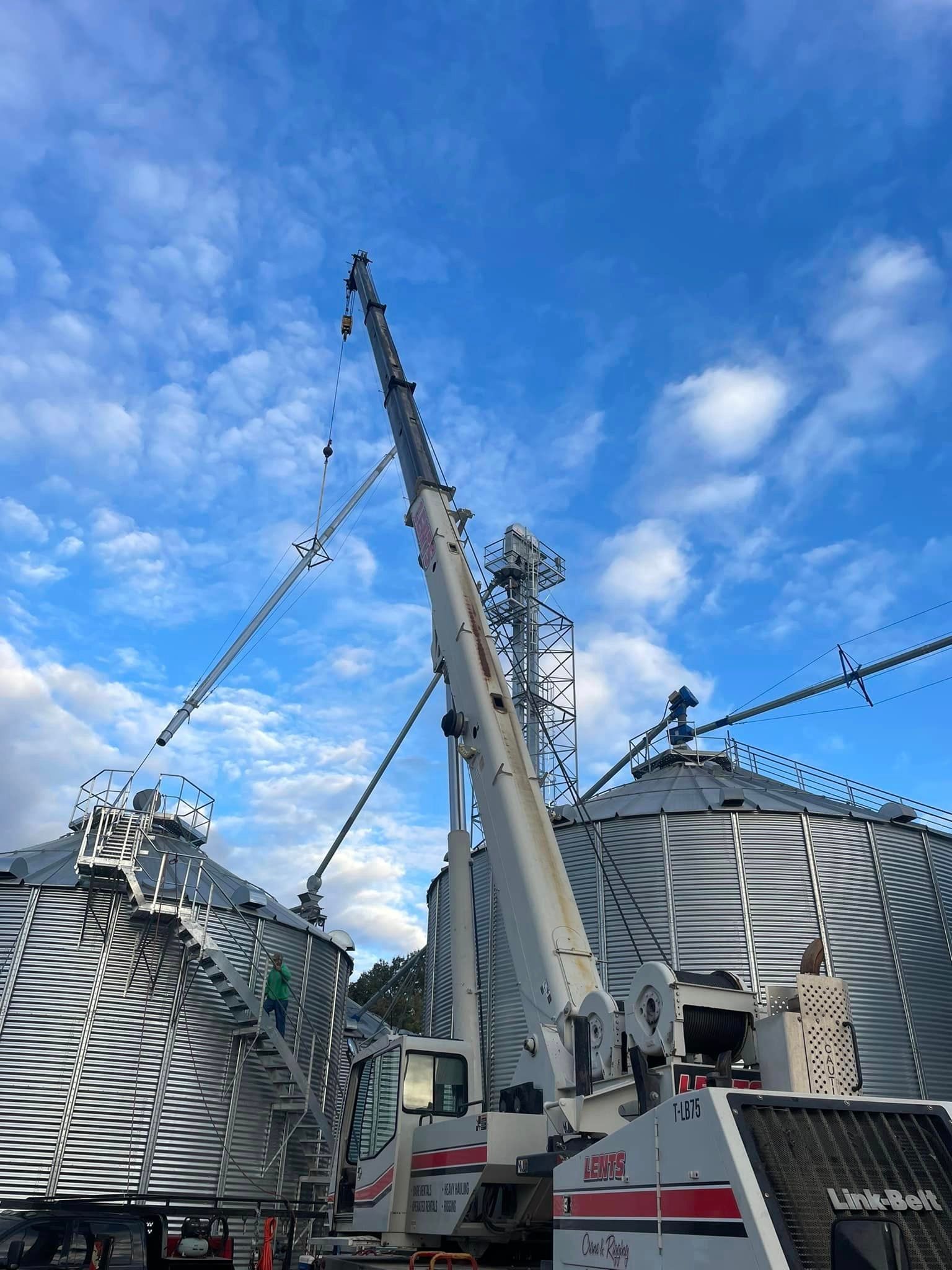 A large crane is lifting a large metal structure.