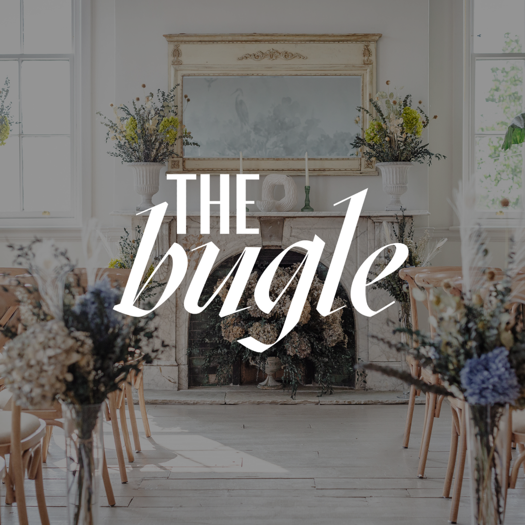 A row of chairs are lined up in front of a fireplace decorated with flowers.
