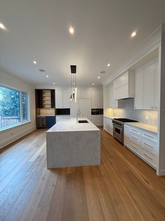 Bright home gym with exercise machines, mirrors, and a large punching dummy on the right