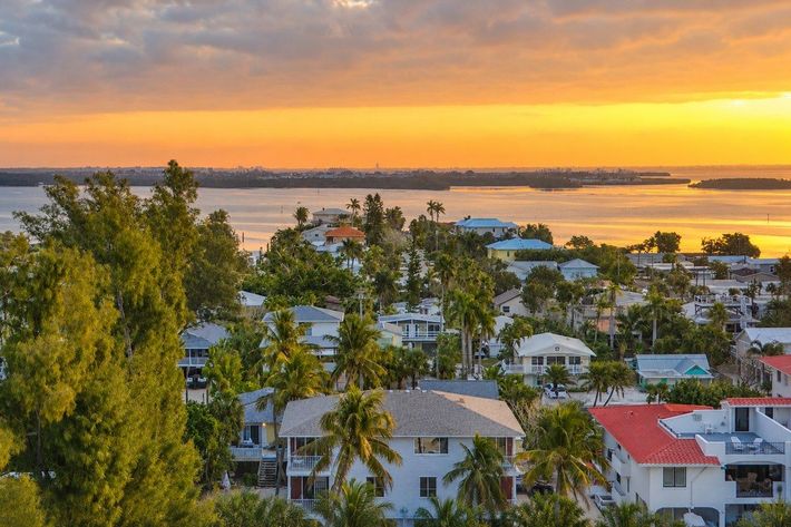 Sunrise over the bay and palm-lined island homes on Anna Maria Island, seen from above near Cedar Cove Resort