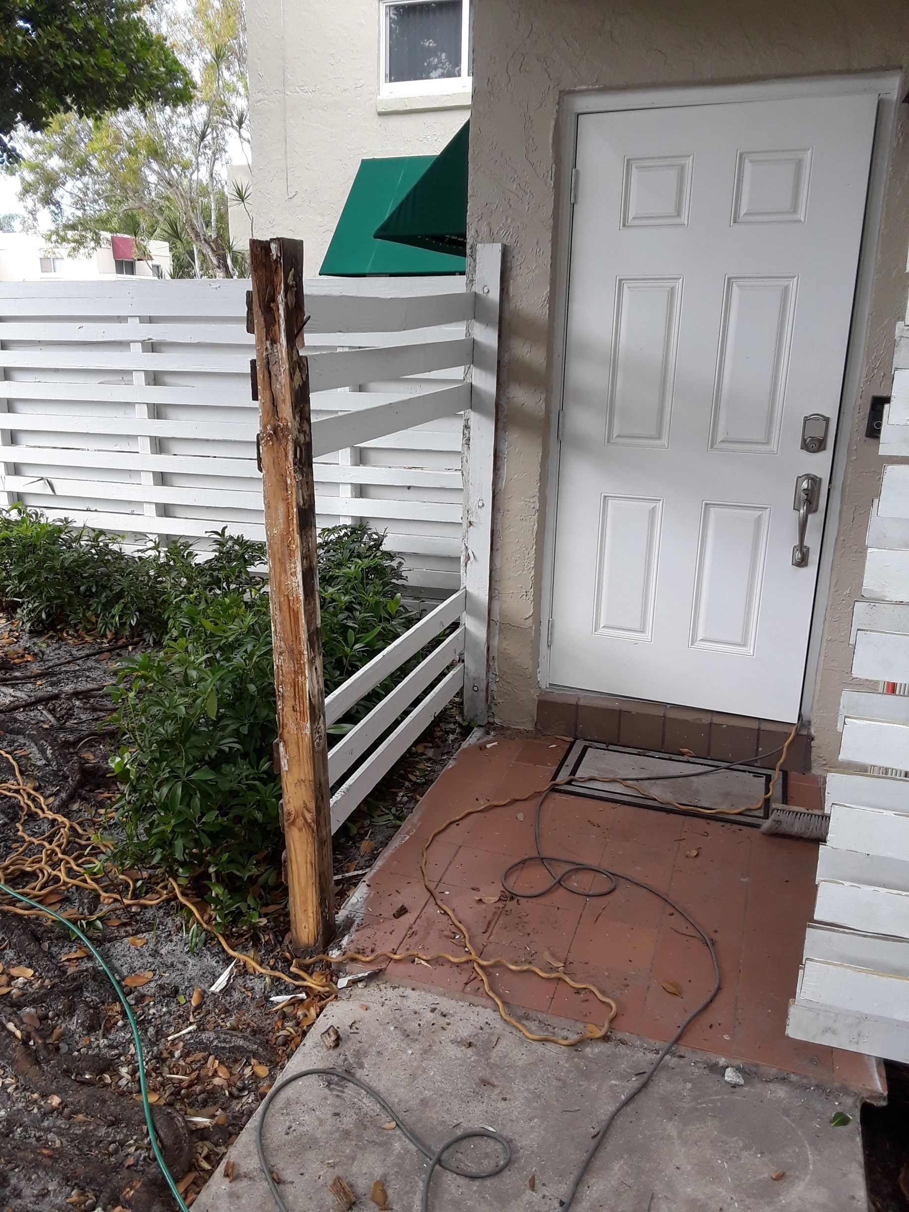 A white door with a wooden fence in front of it