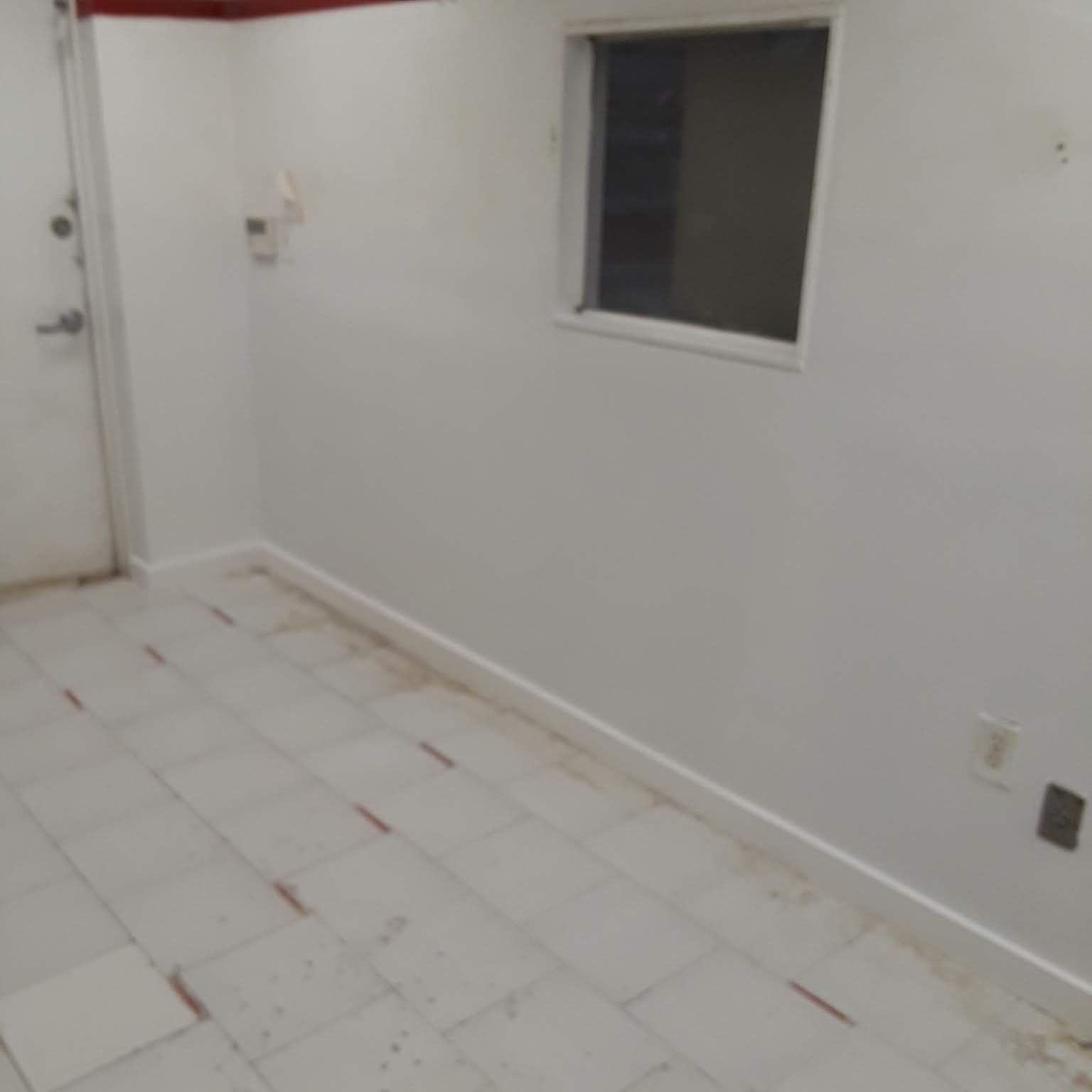 There is a window in the wall of the room.