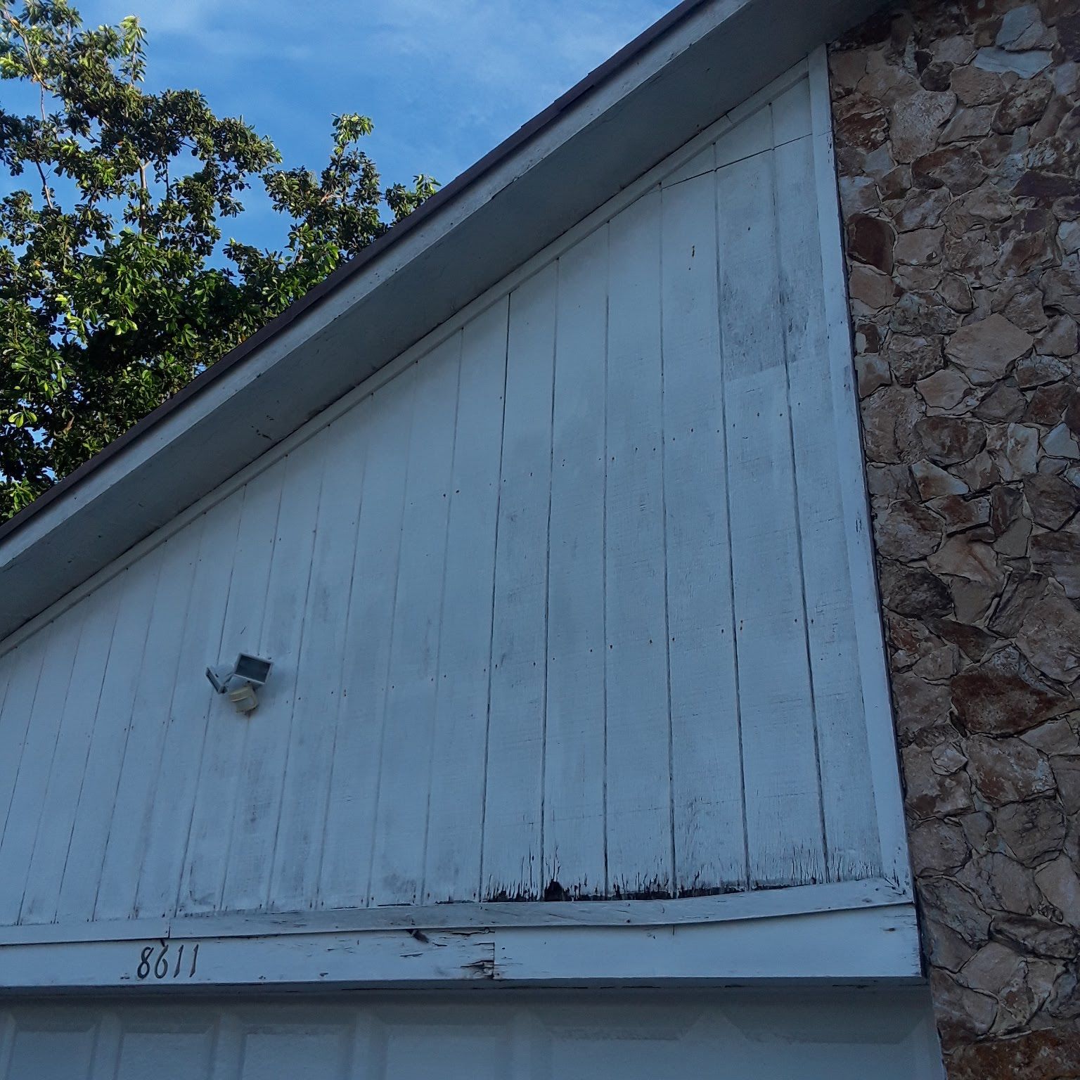 A white garage door with the number 831 on it