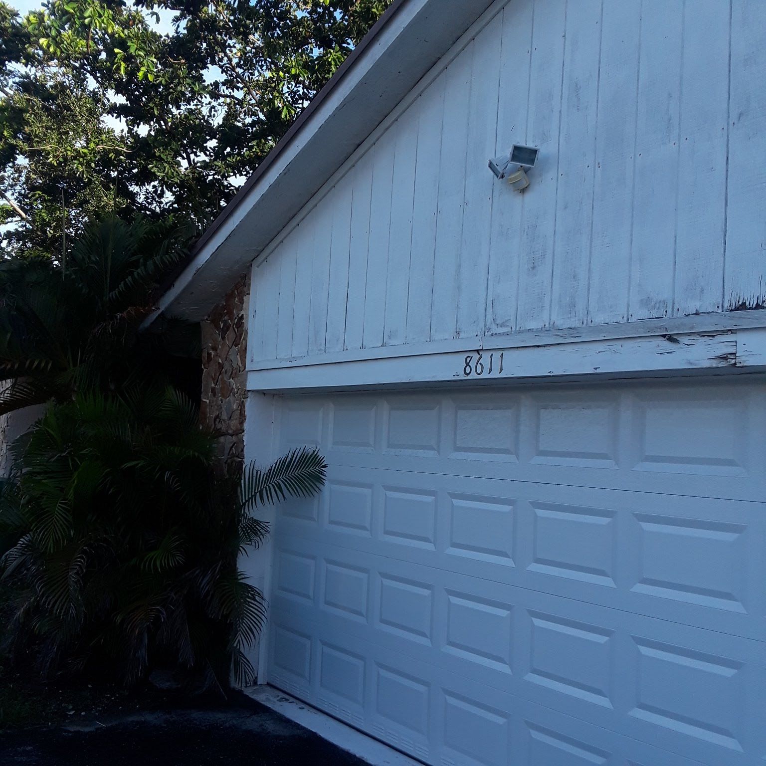 A white garage door with the number 8731 on it