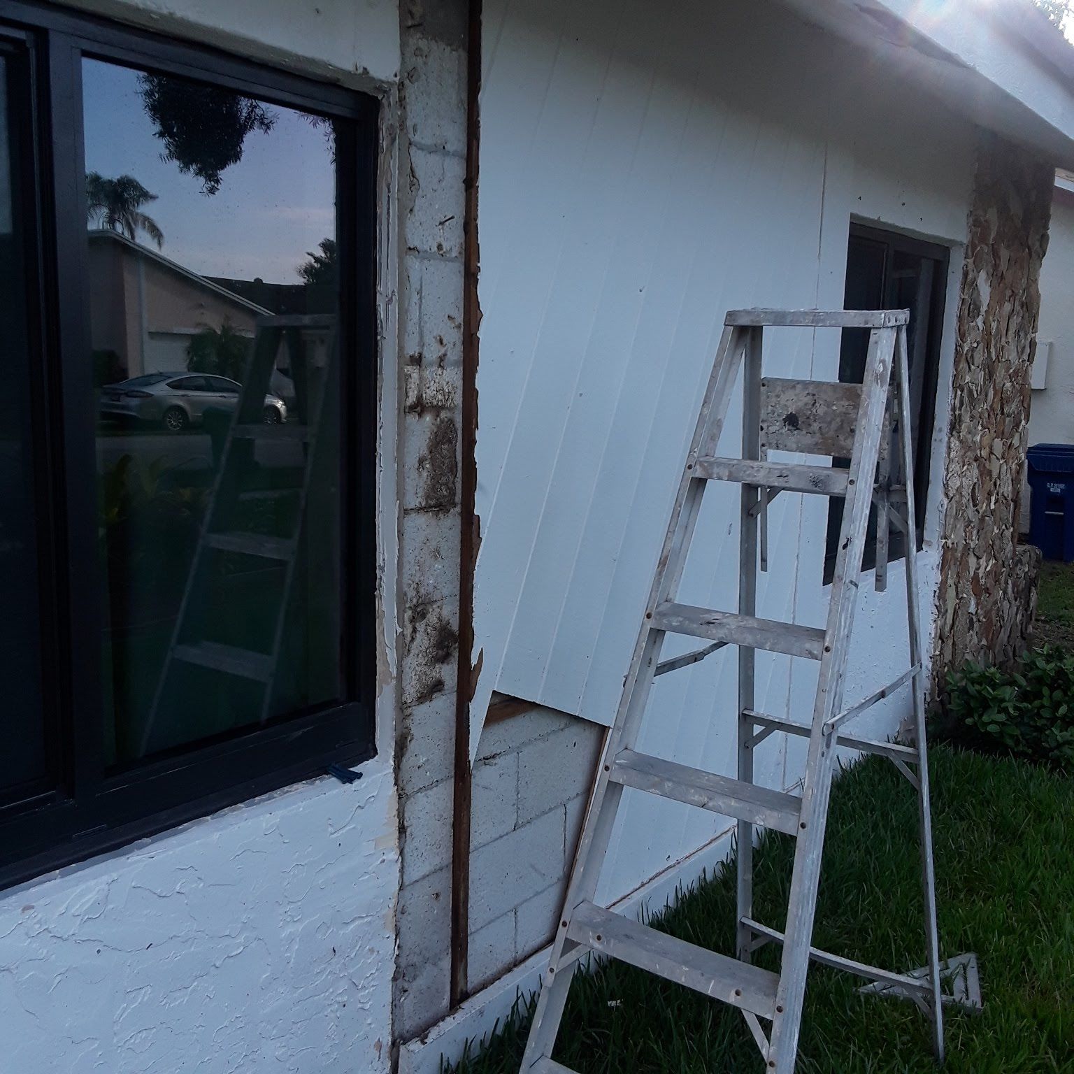 A ladder is leaning against the side of a house