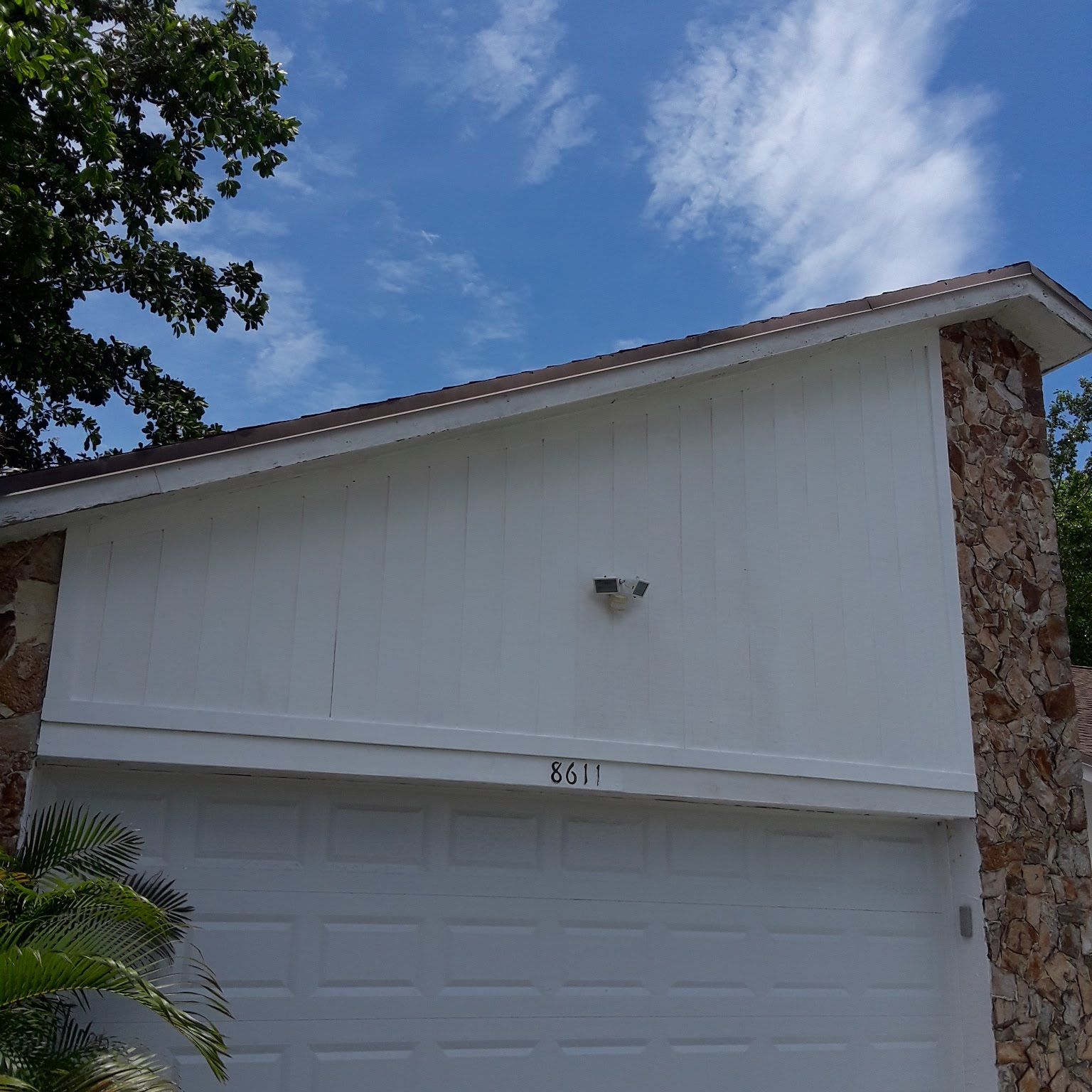A white garage door with the number 25 on it