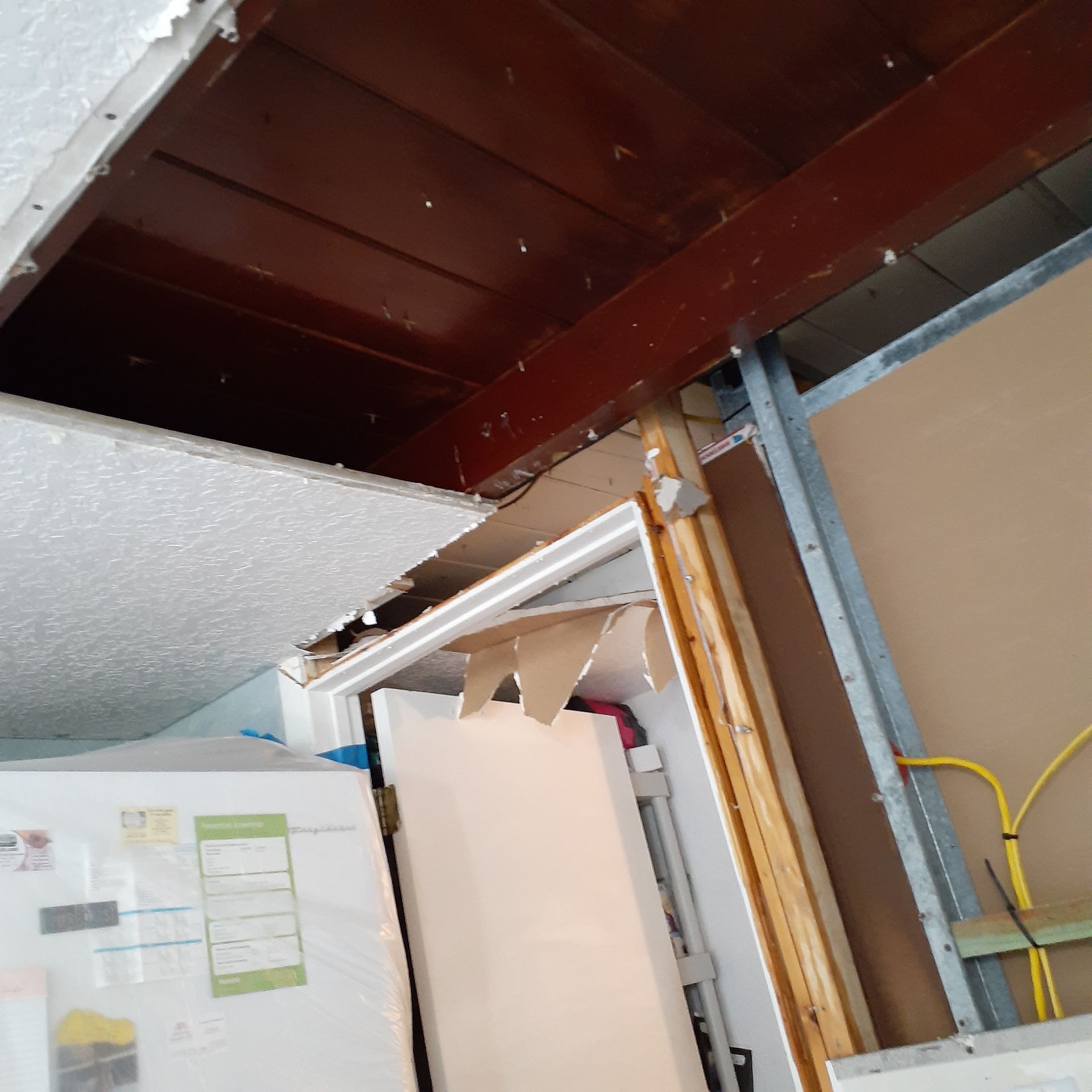 A room with a ceiling that has a hole in it