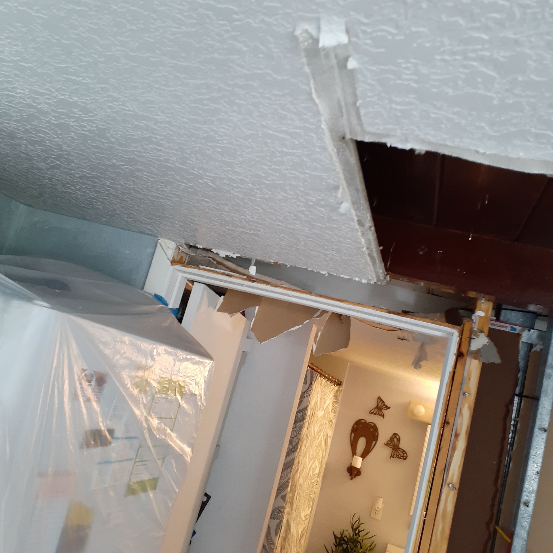 A room with a ceiling that has a hole in it