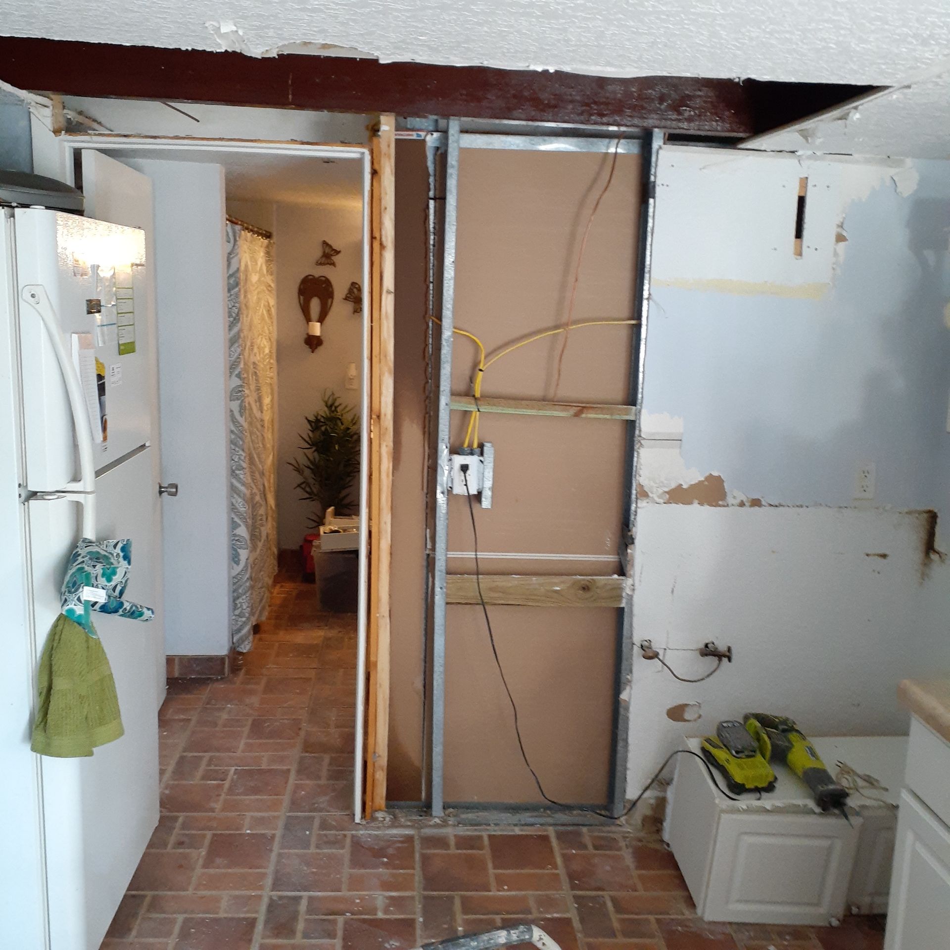 A kitchen with a door that is being remodeled