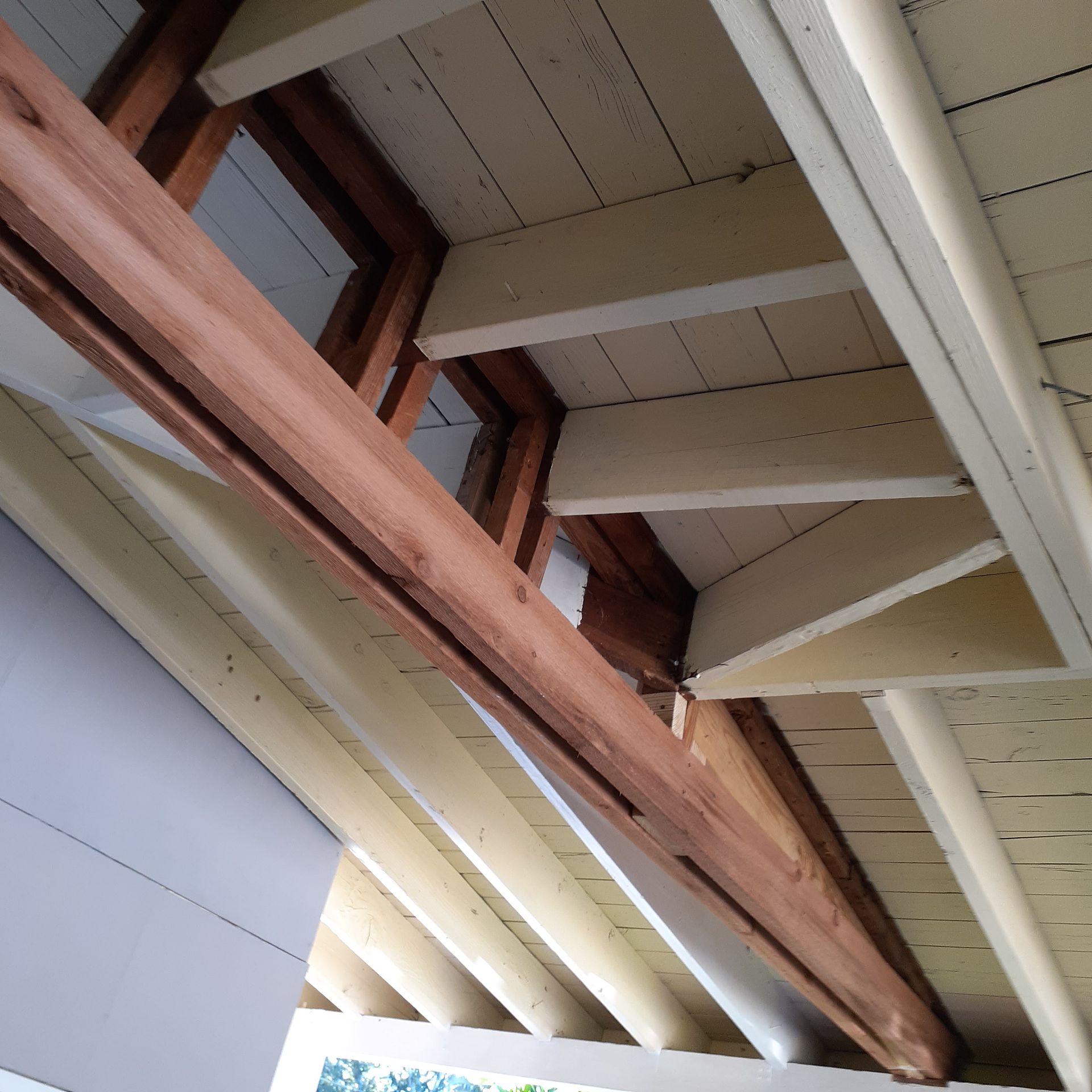 Looking up at the ceiling of a building with wooden beams