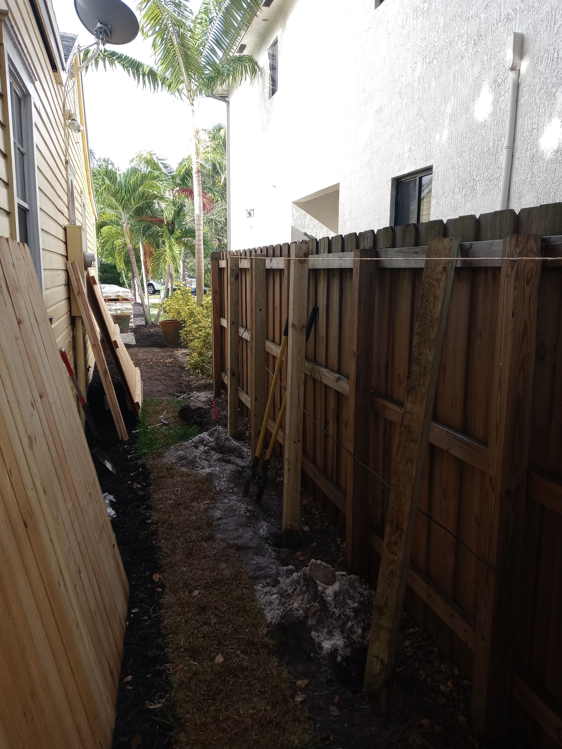A wooden fence along the side of a house