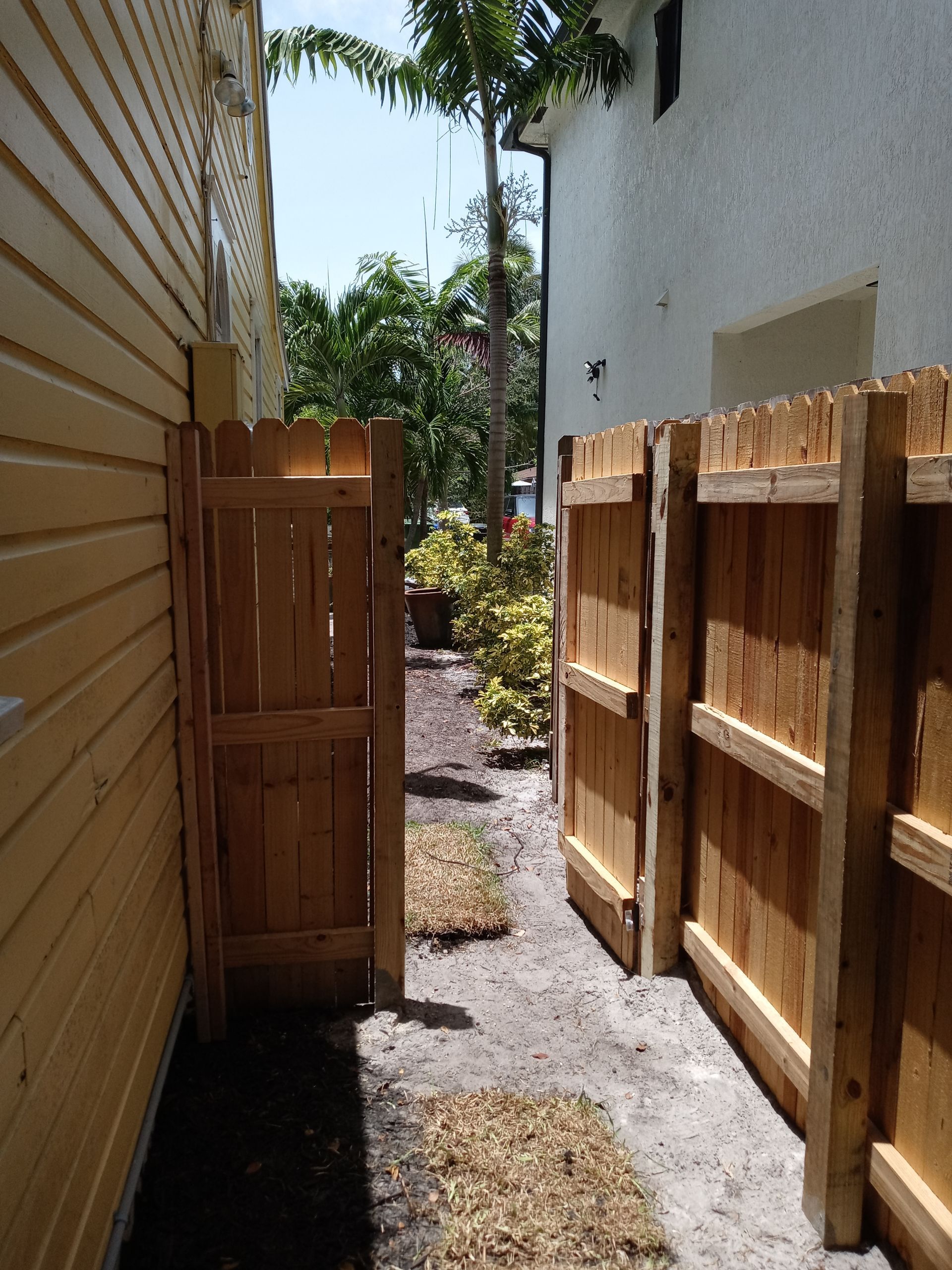 A wooden fence along the side of a house