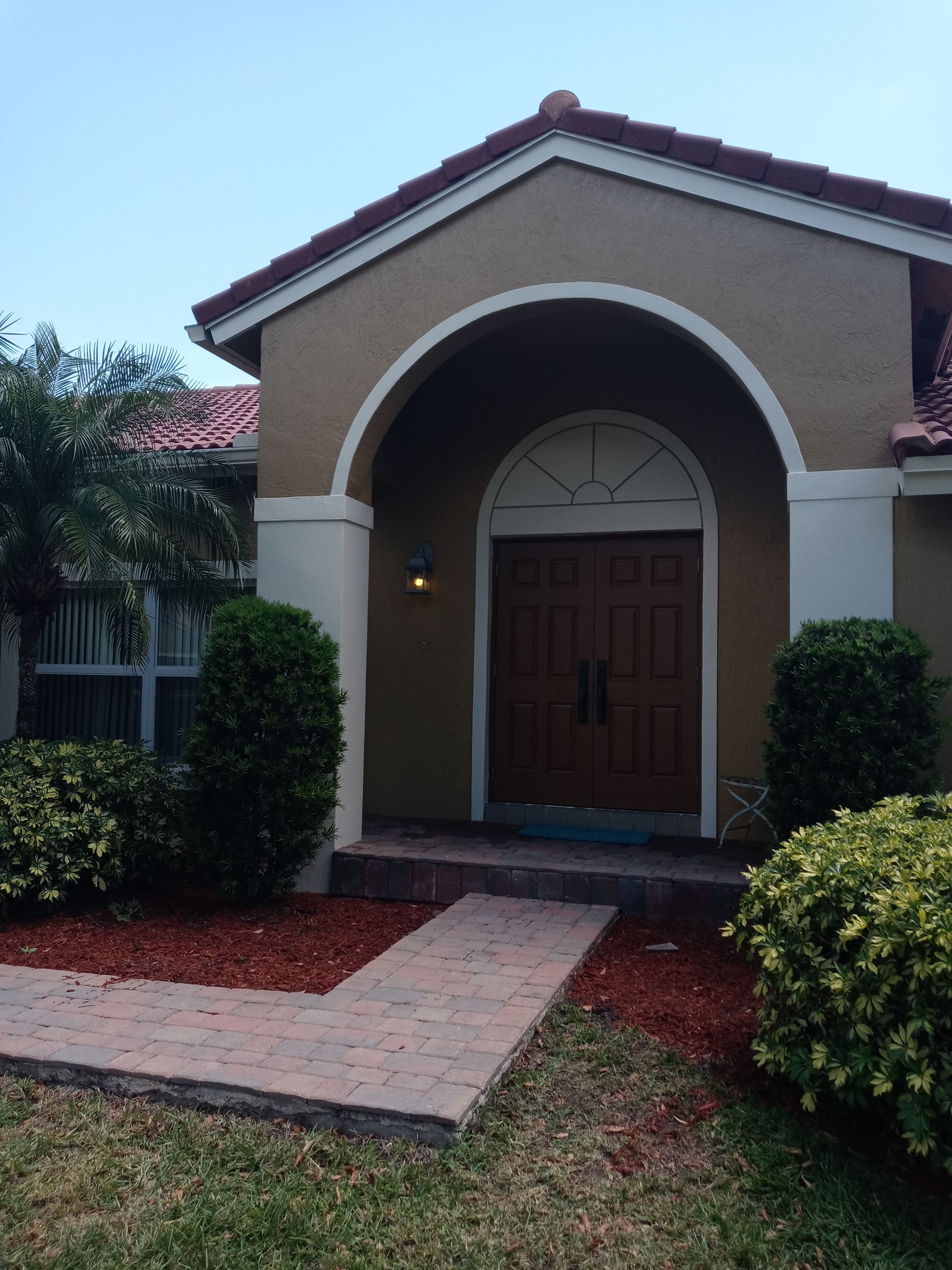 A house with a walkway leading to the front door