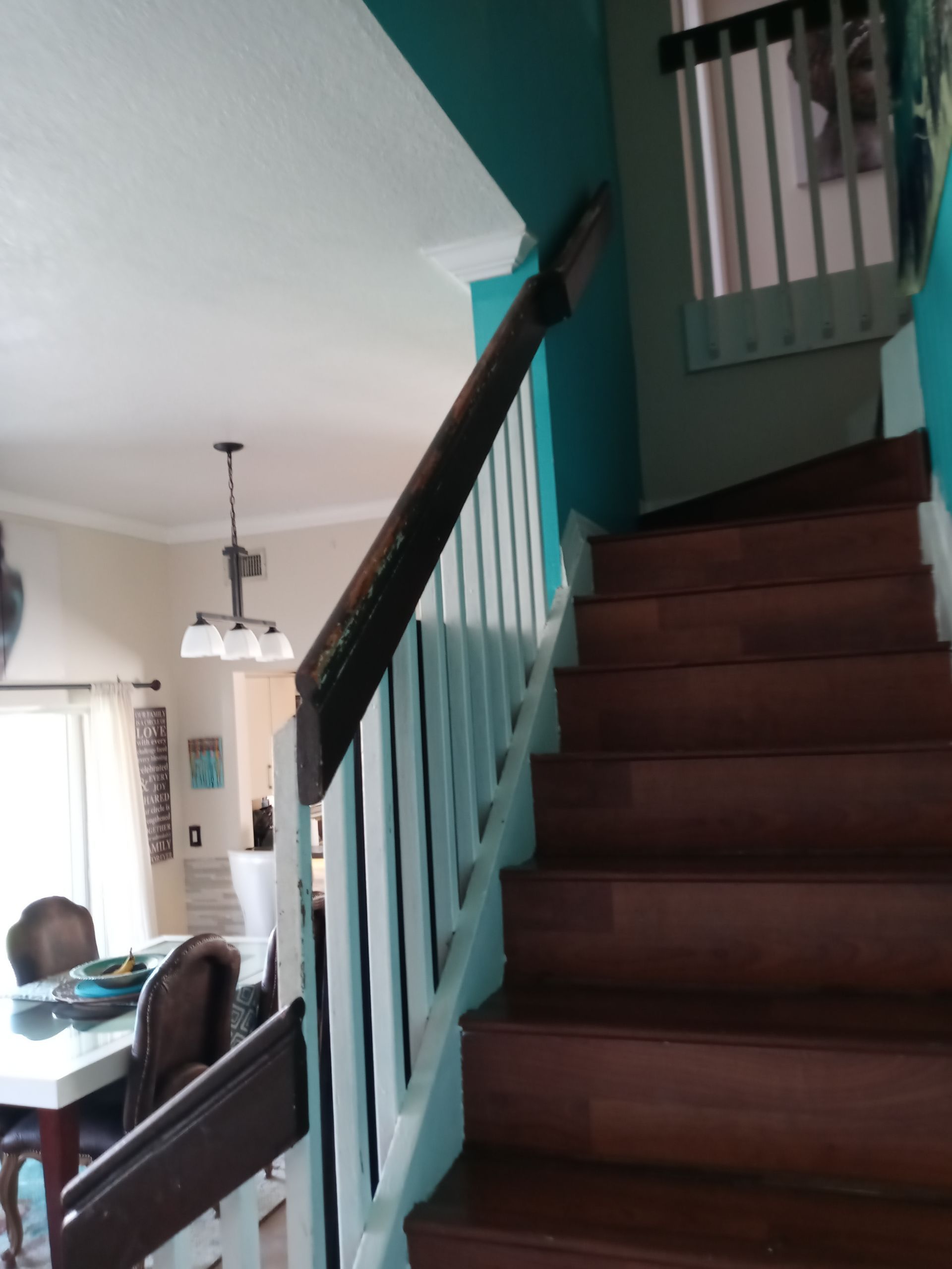 A wooden staircase leading up to the second floor of a house