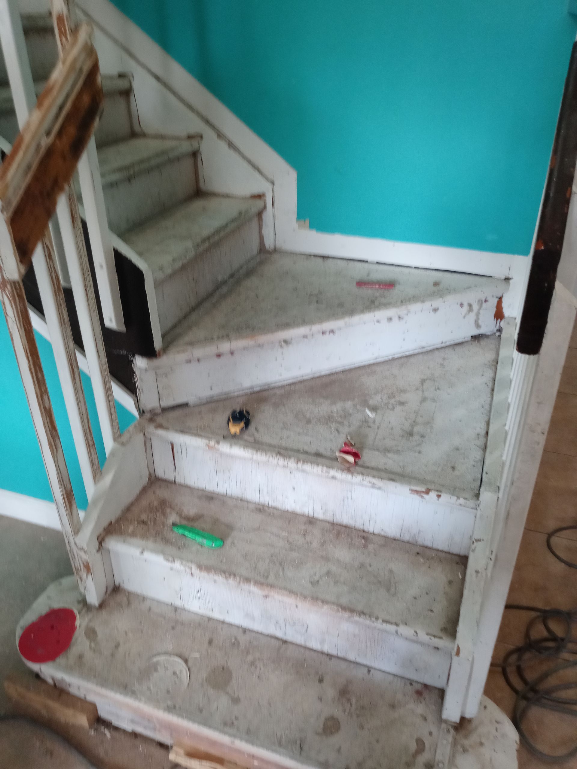 A dirty staircase with a blue wall behind it