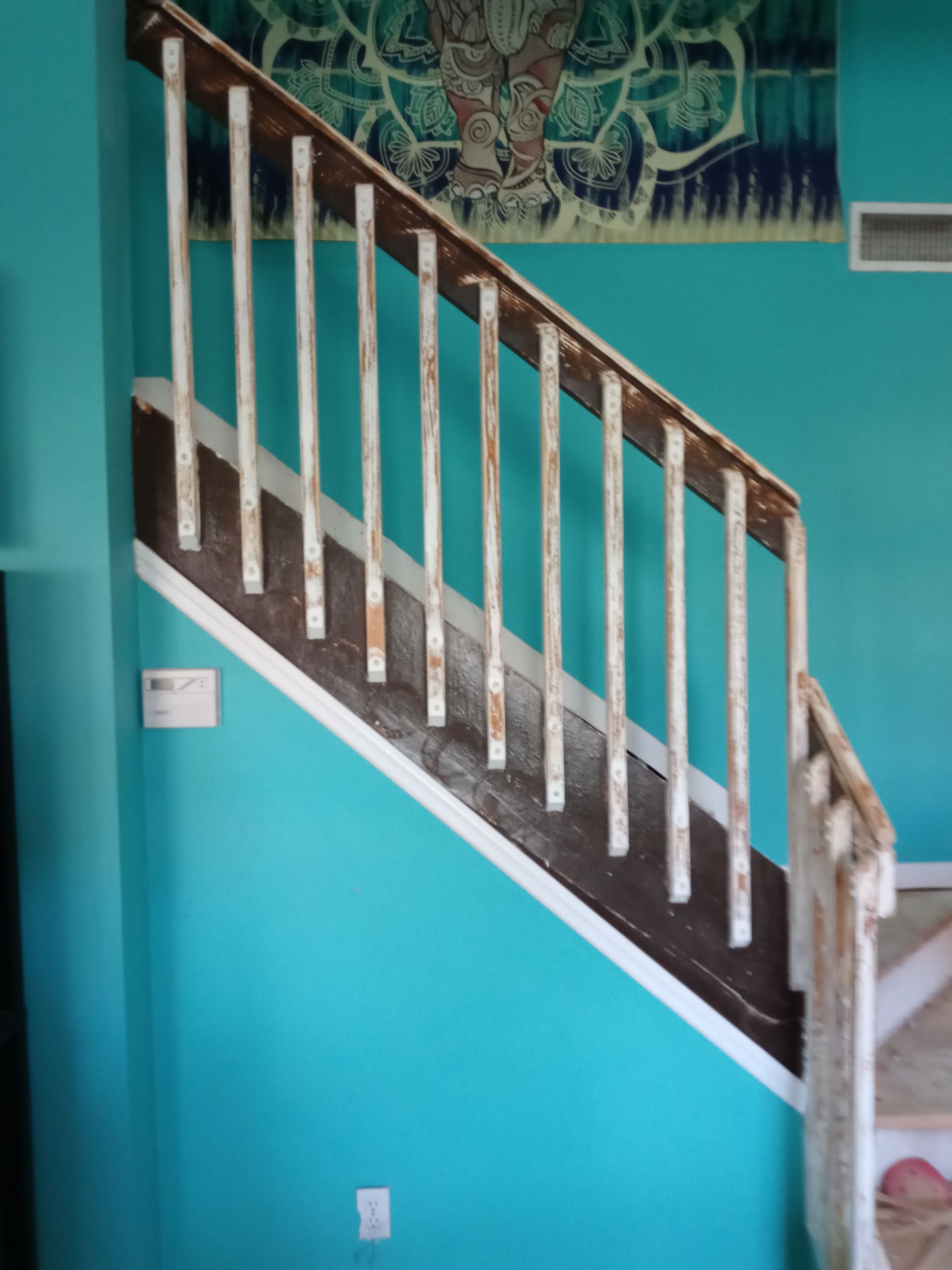 A staircase with blue walls and a white railing