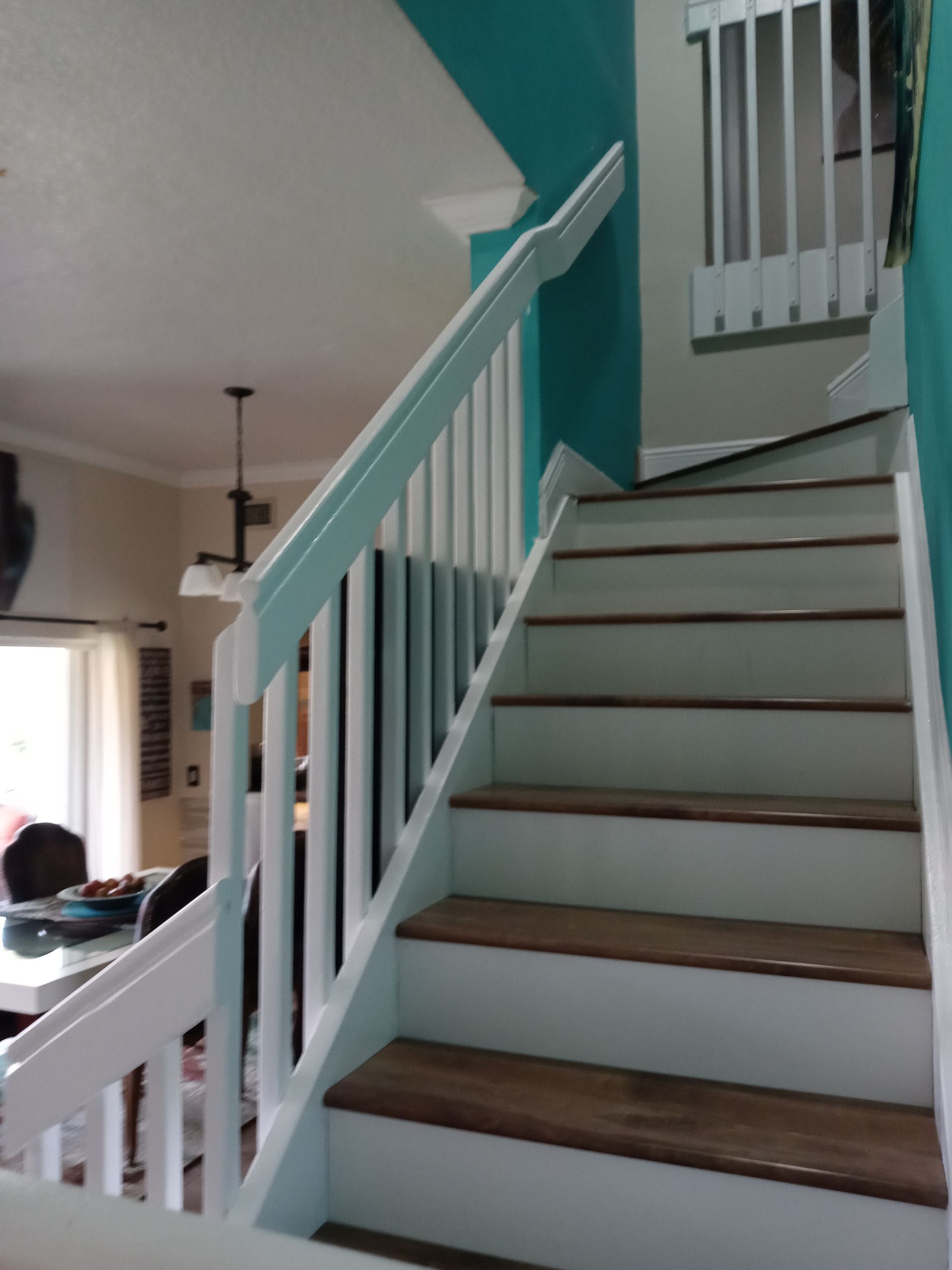 A staircase with a white railing and wooden steps