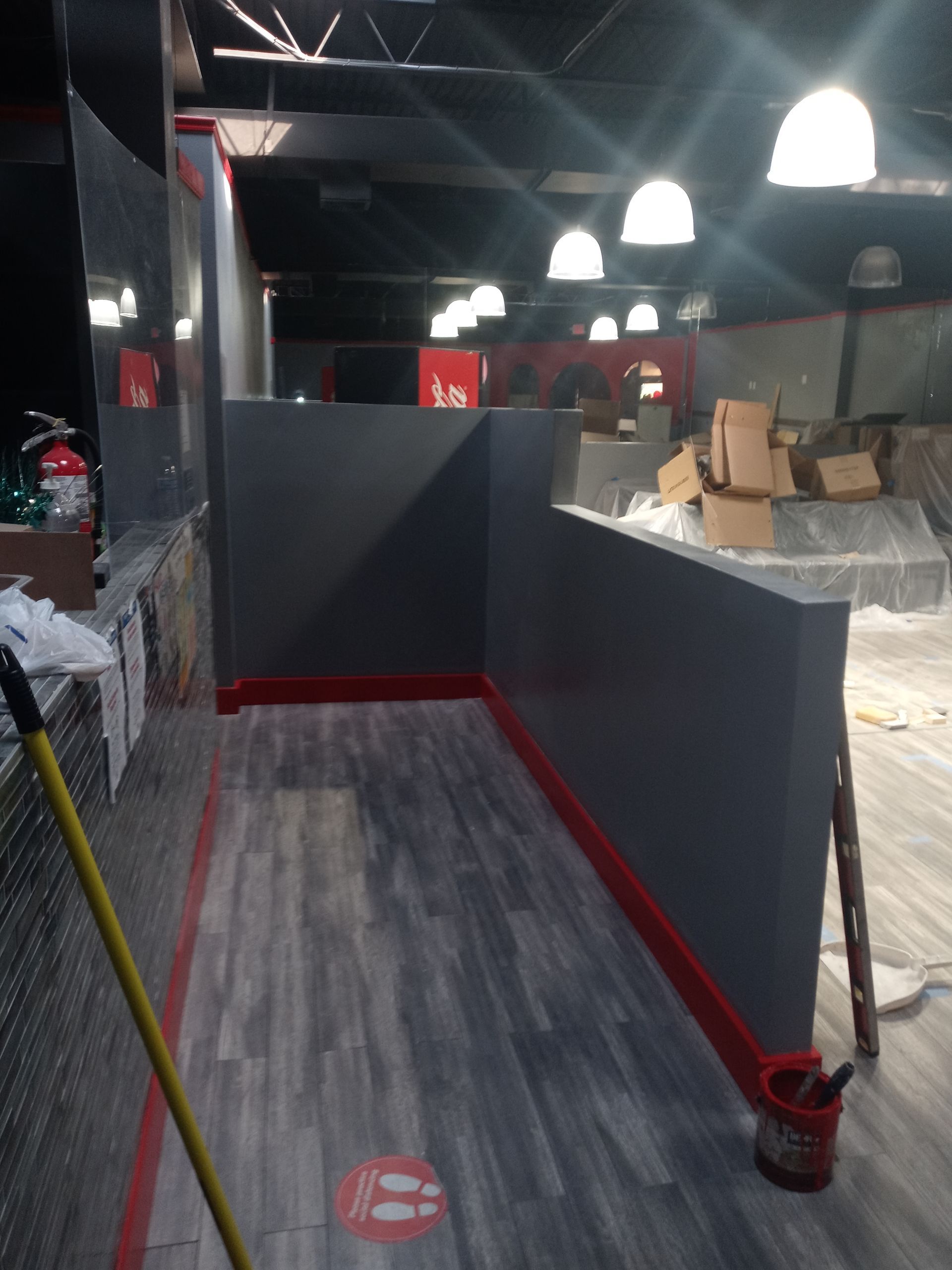 A room with a mop and a bucket of paint on the floor