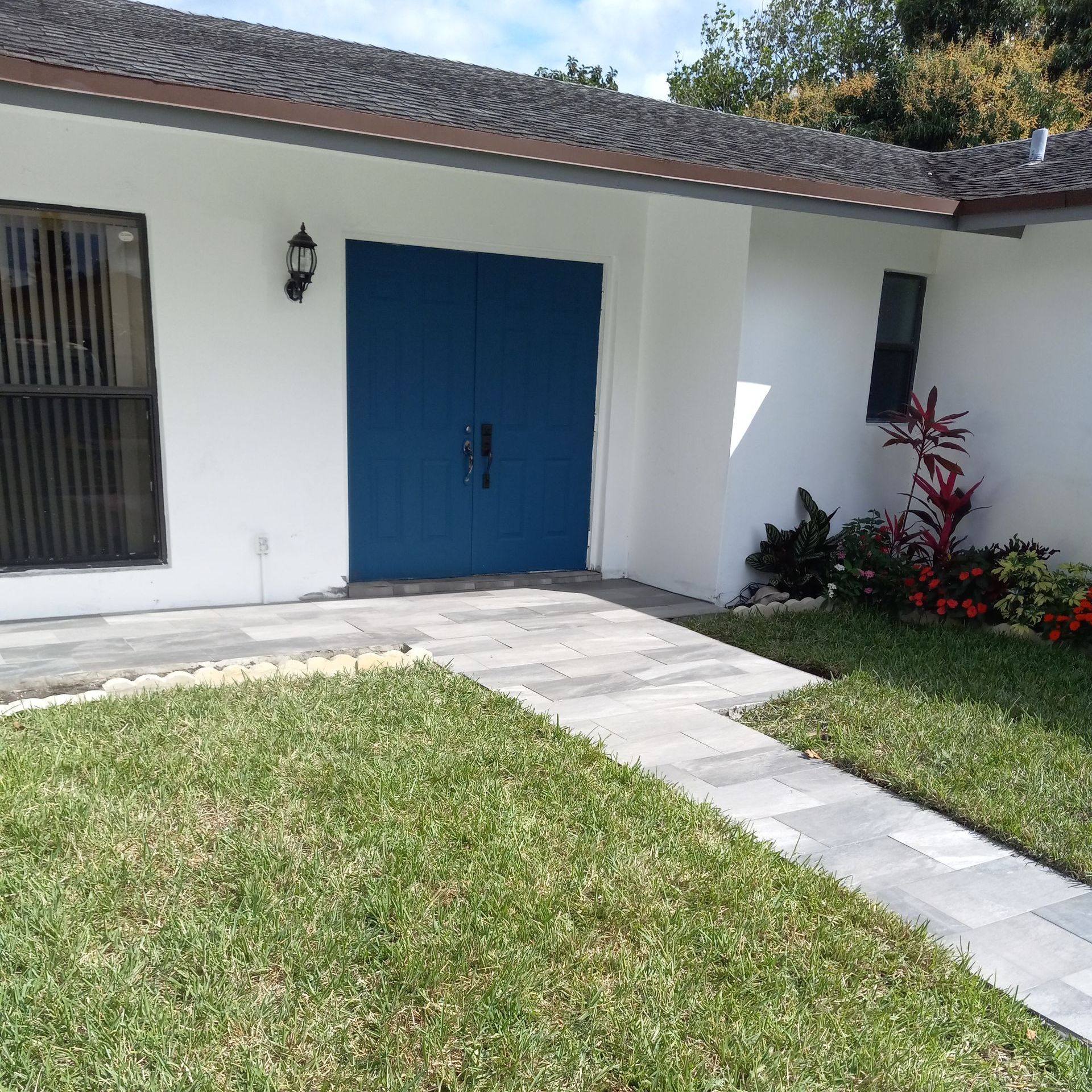 A white house with a blue garage door